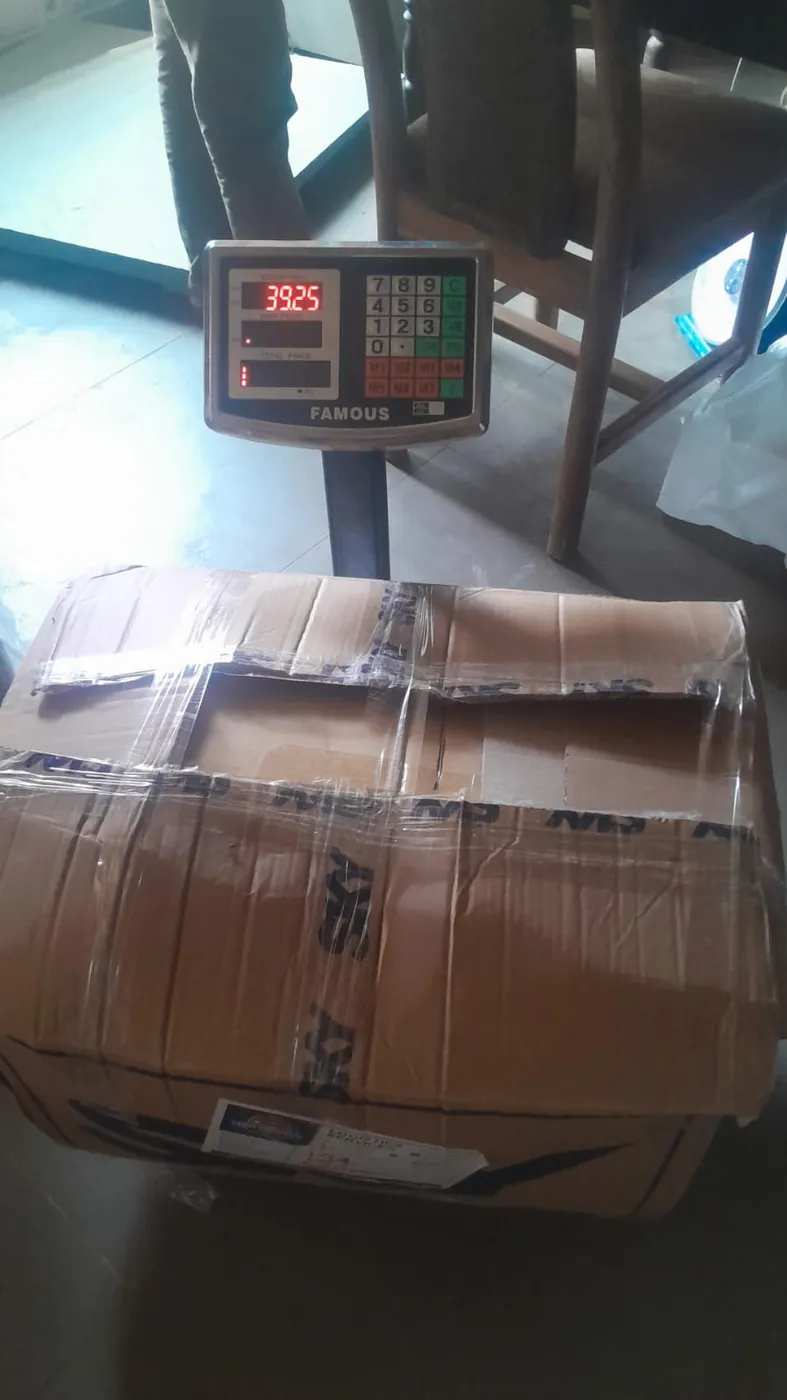 Boxed consignment being weighed on a digital scale