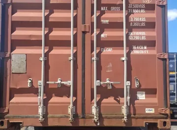A 40ft shipping container on a trailer, loaded for Nigeria