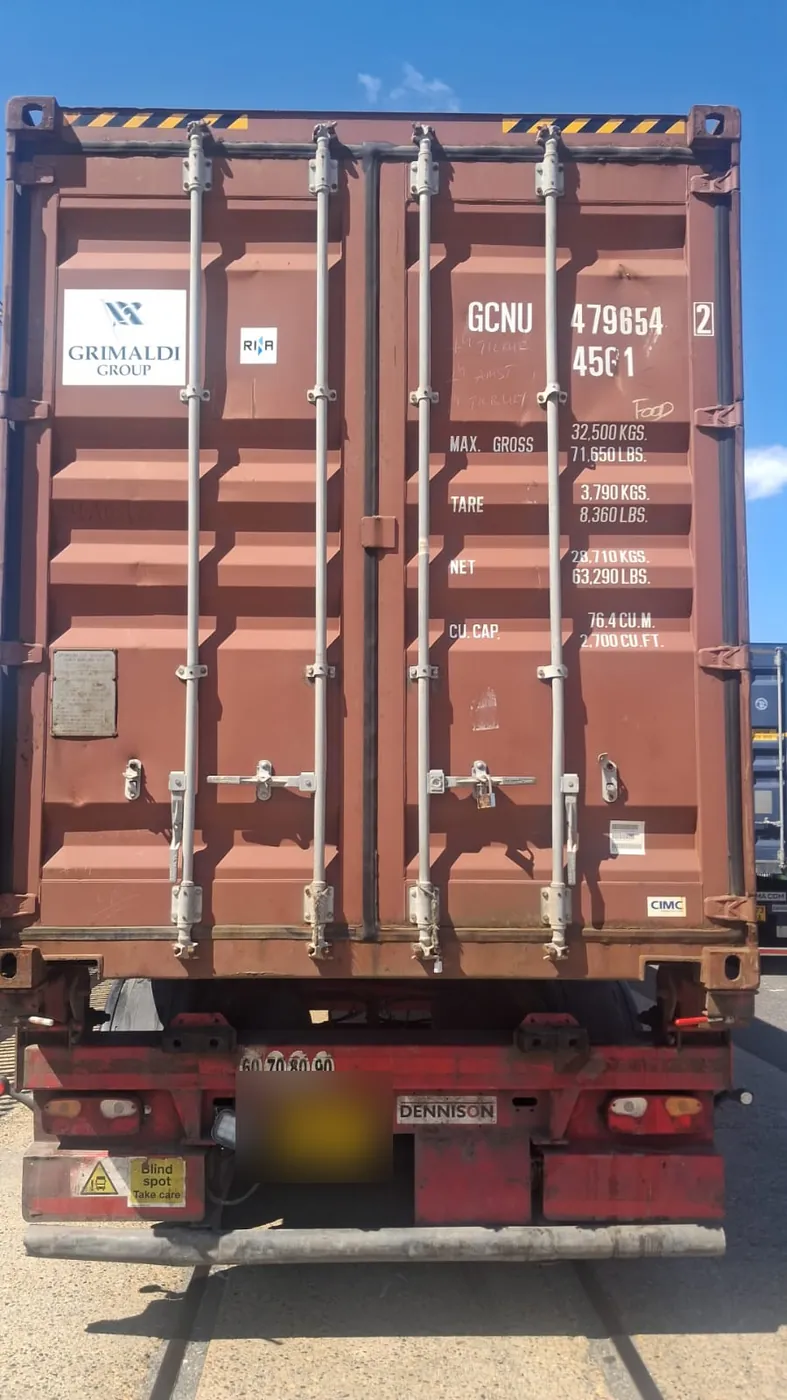 40ft high-cube shipping container on a truck, doors closed and sealed